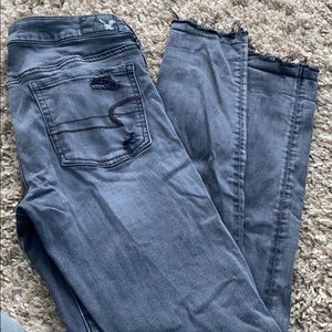 Grey AE knee-ripped jeans